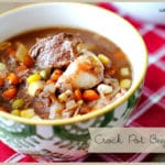 Bowl of beef stew sitting on a linen napkin.