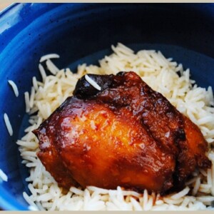Honey Asian chicken served over a bowl of white rice.