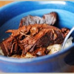 Sweet and spicy Asian boneless ribs in a blue bowl served with white rice.