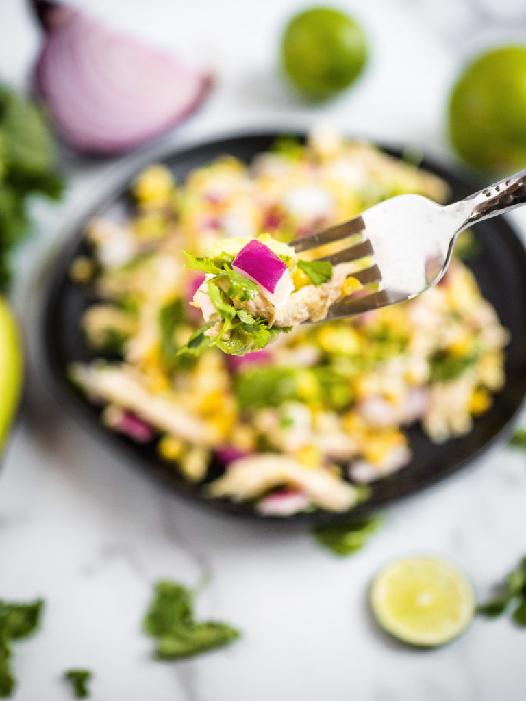 a bite of the salad on a silver fork