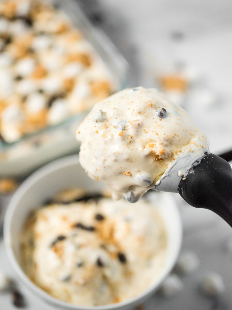 ice cream in a scoop topped with graham cracker crumbs and chocolate chips