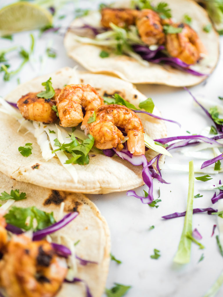 chili lime shrimp tacos in charred white corn tortillas with cabbage slaw
