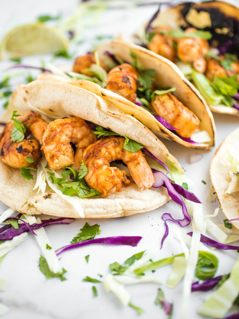 chili lime shrimp tacos in charred white corn tortillas with cabbage slaw