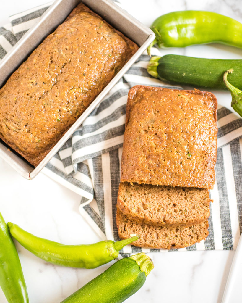 overhead shot of green chile zucchini bread next to a second loaf still in the pan