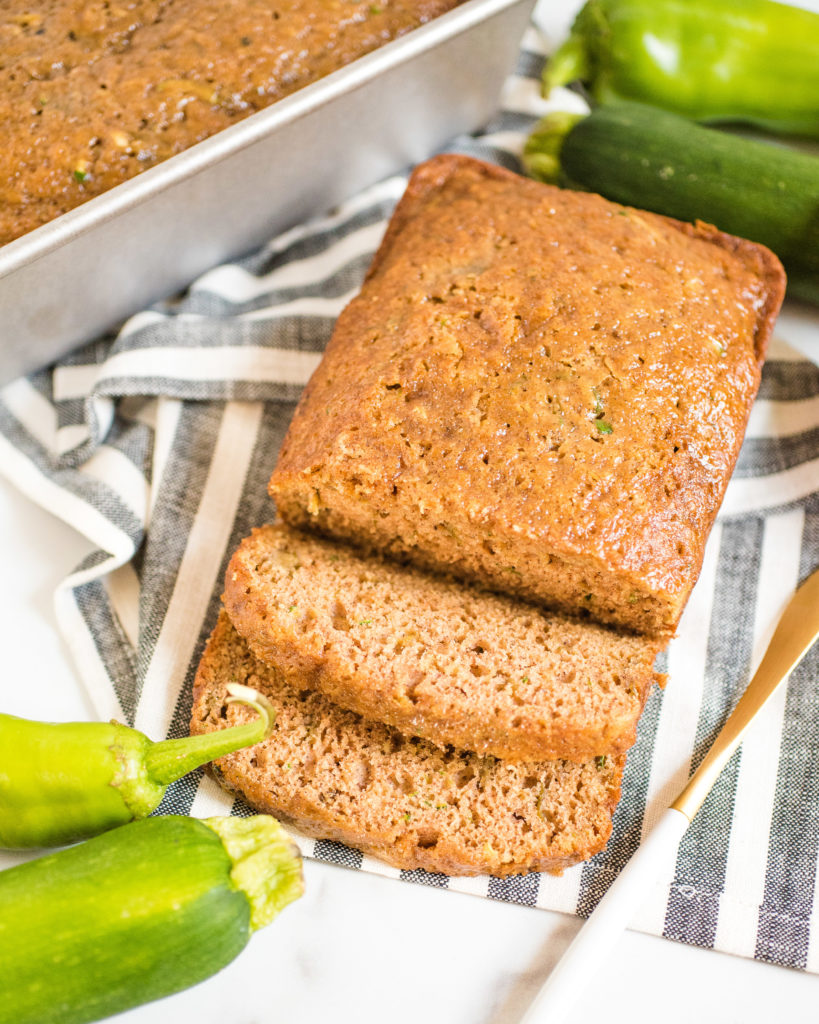 overhead shot of green chile zucchini bread with two slices cut