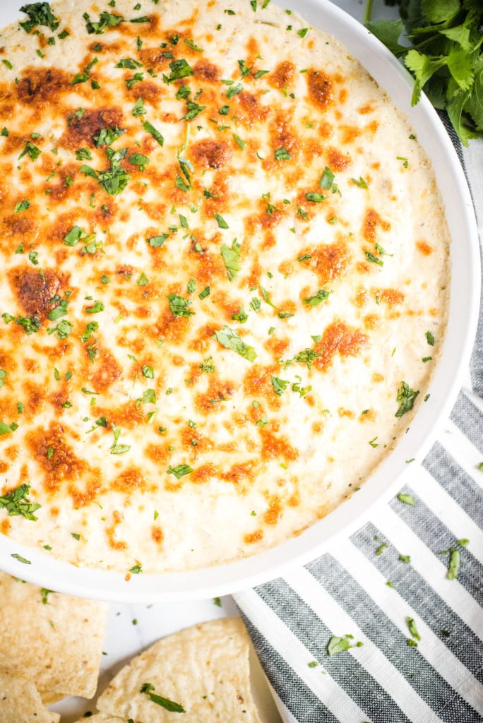 Overhead shot of green chile queso blanco topped with chopped cilantro