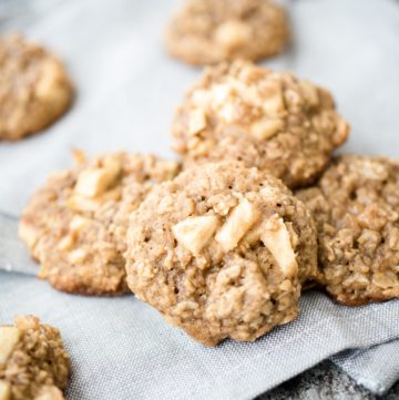 apple cinnamon oatmeal cookies on a grey cloth