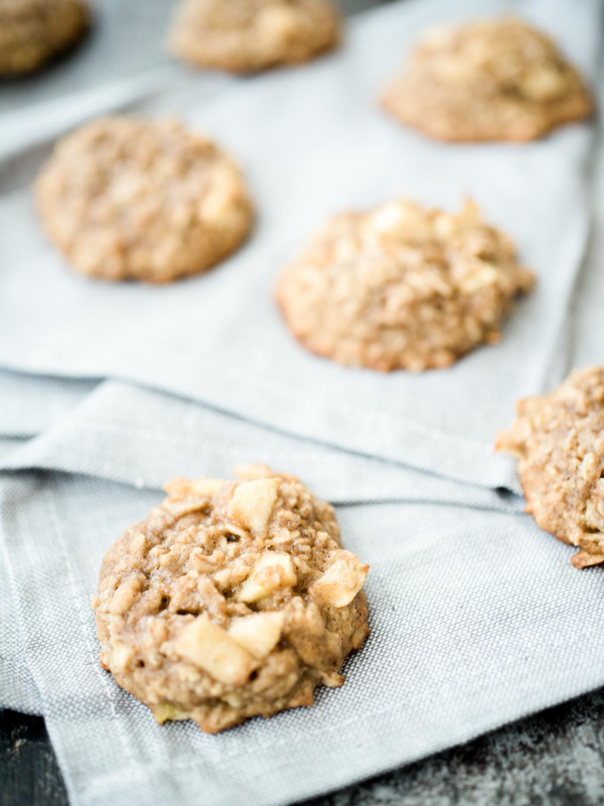 apple cinnamon oatmeal cookies on a grey cloth