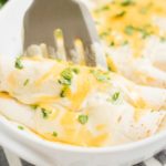 enchiladas being scooped from dish