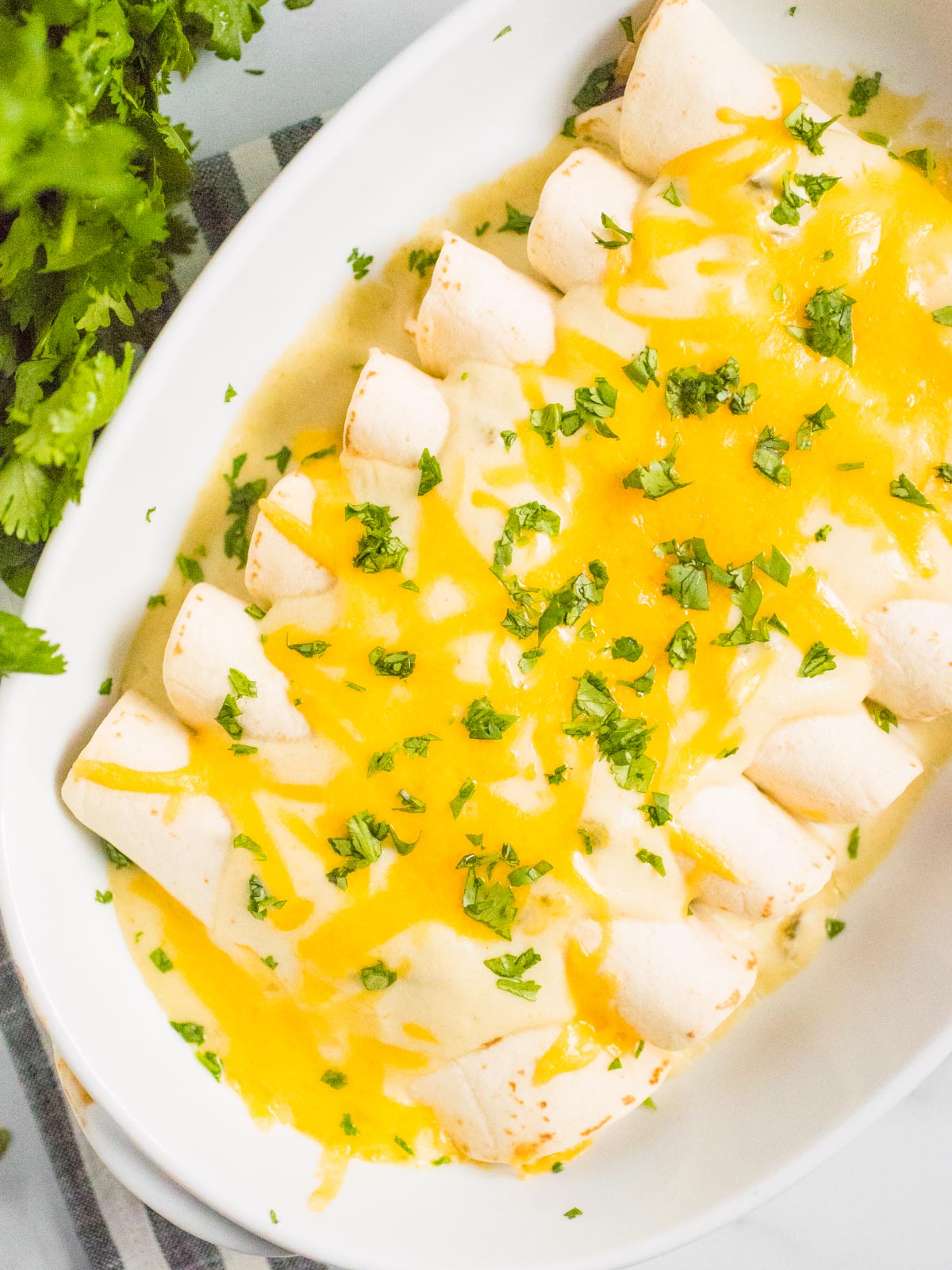 enchiladas in a white baking dish