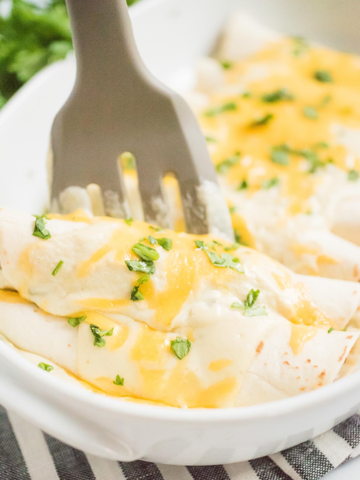 enchiladas being scooped from dish