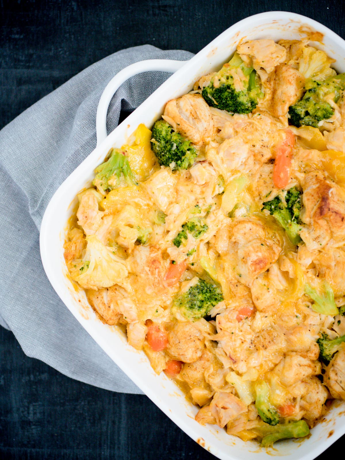 Cheesy Chicken and Veggie Bubble Up in a white baking dish