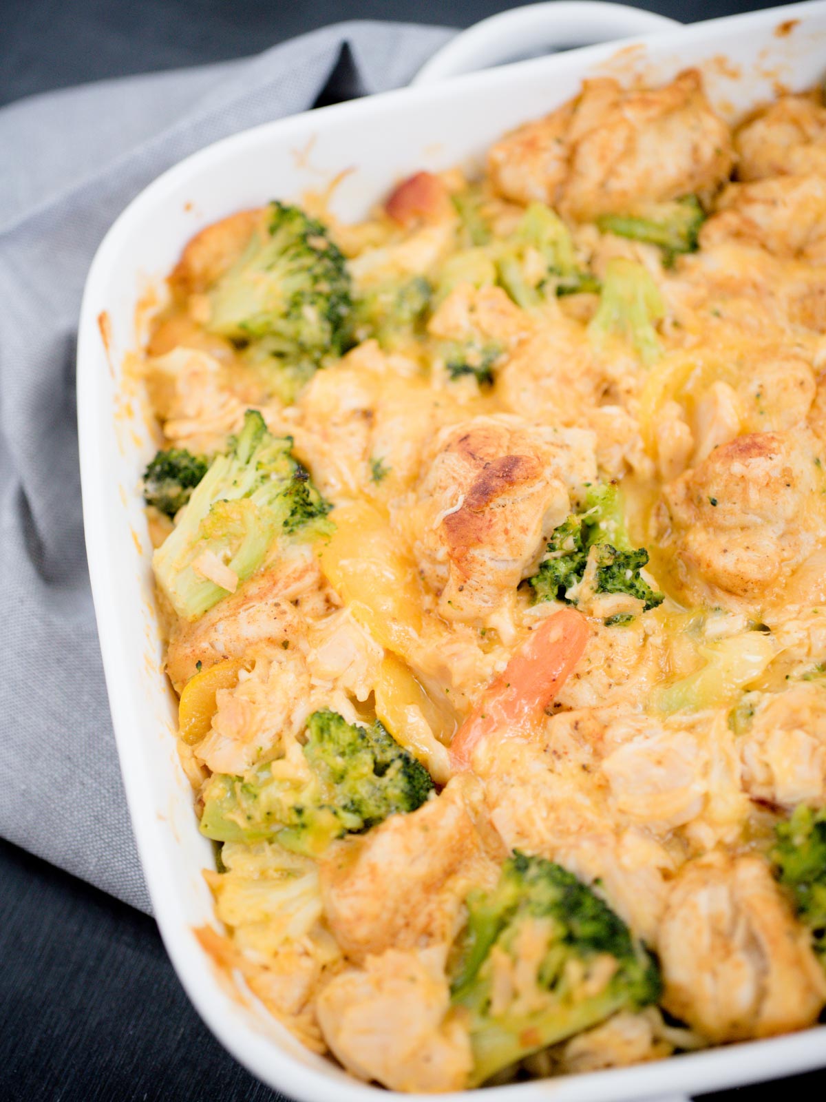 Cheesy Chicken and Veggie Bubble Up in a white baking dish