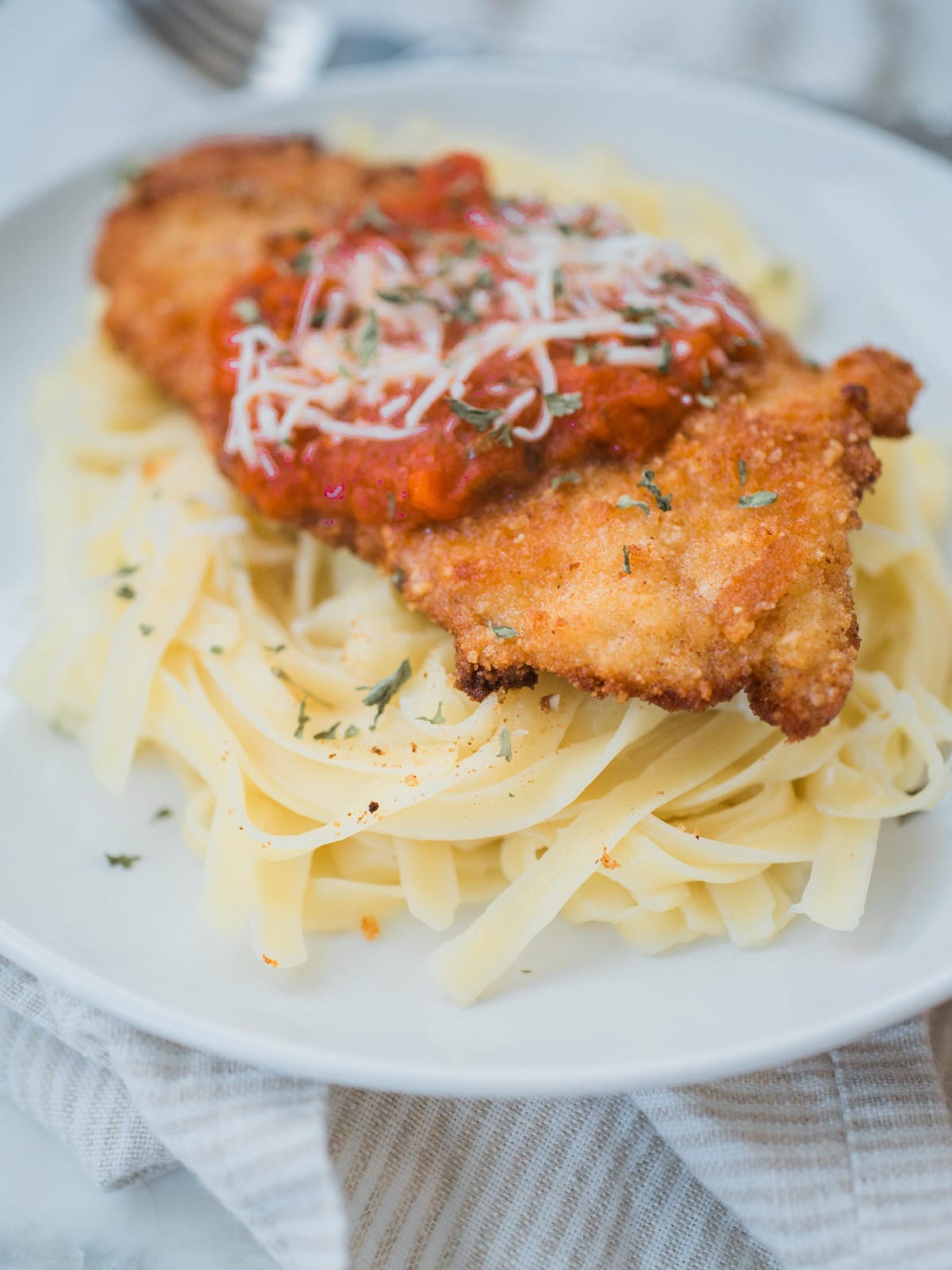 chicken parmesan on top of pasta