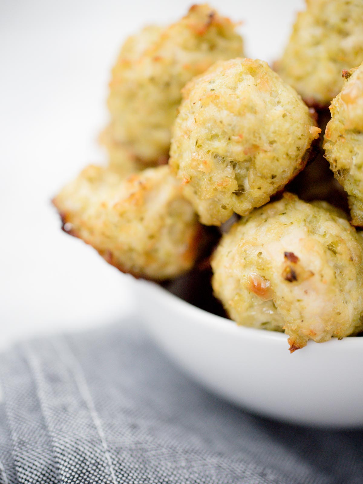 white bowl full of chicken pesto meatballs