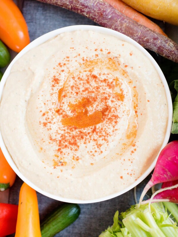 hummus sprinkled with paprika in white bowl
