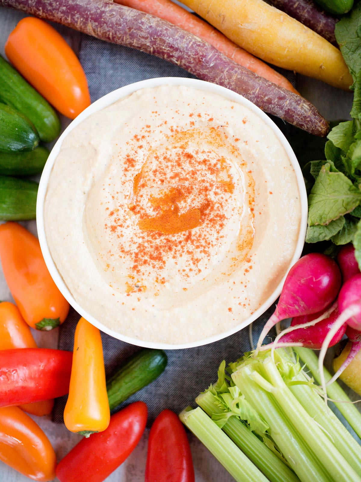 hummus in white bowl sprinkled with paprika