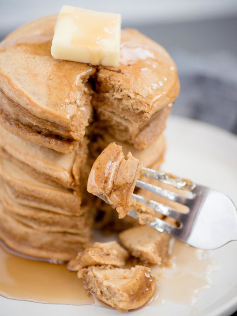 gingerbread pancakes being sliced with a fork