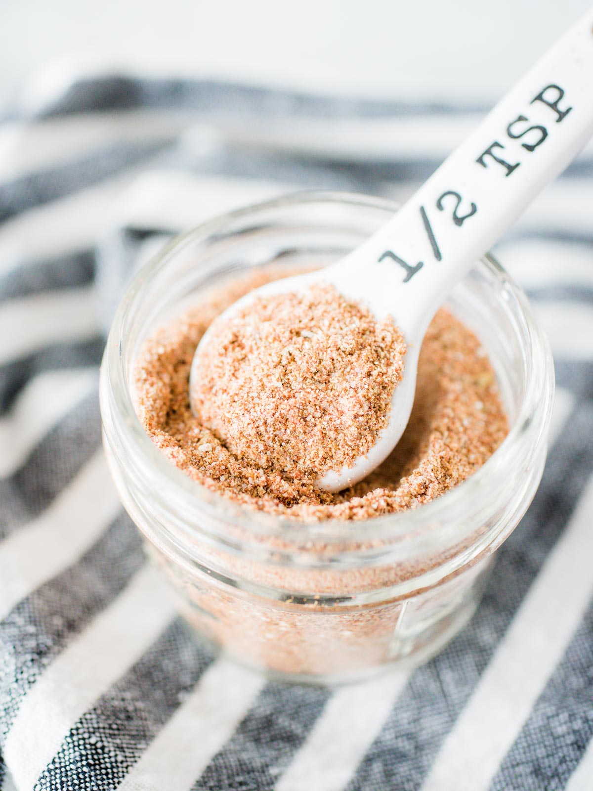 homemade taco seasoning in a jar with a measuring spoon
