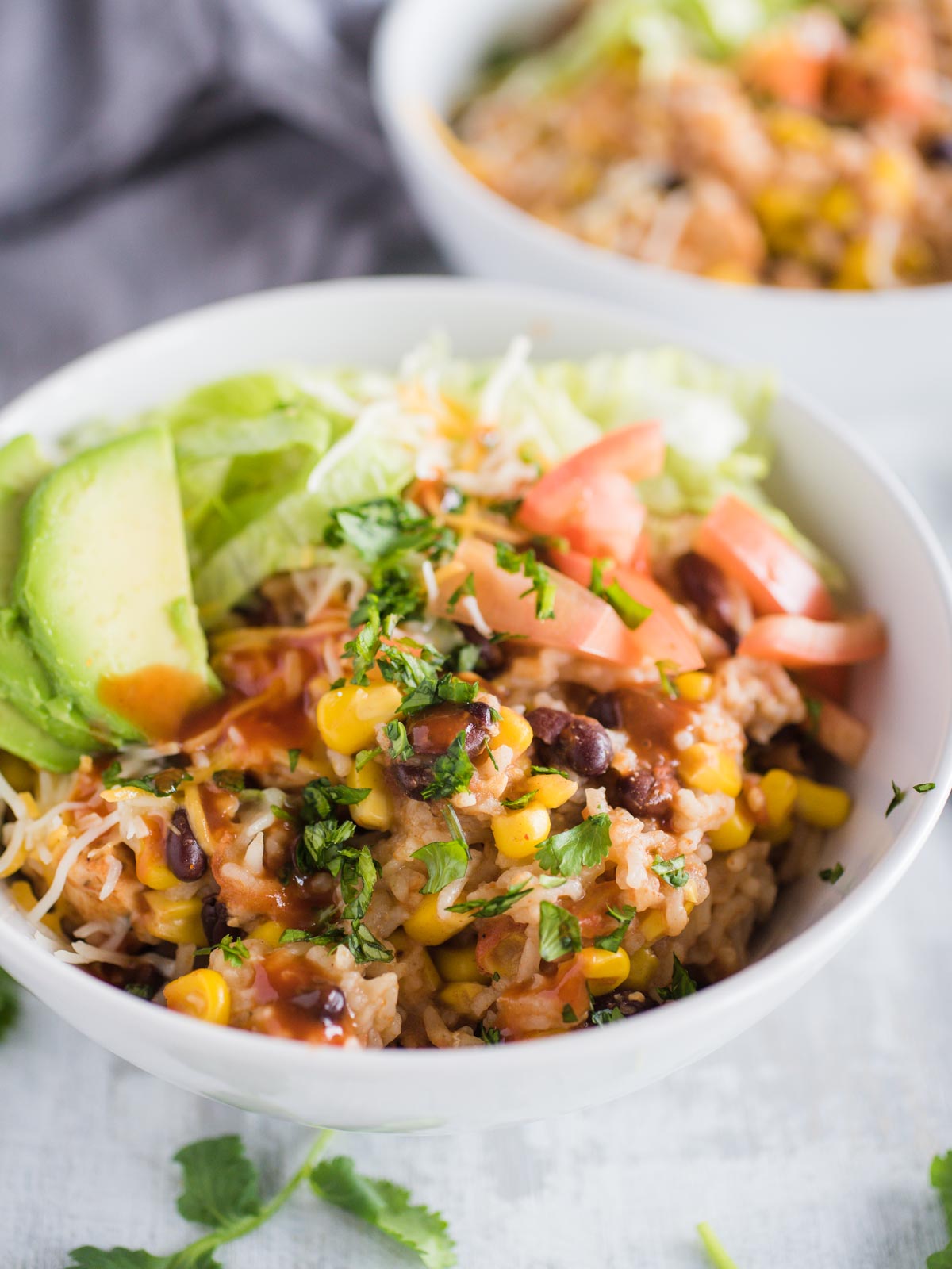 up close shot of instant pot chicken burrito bowl with toppings