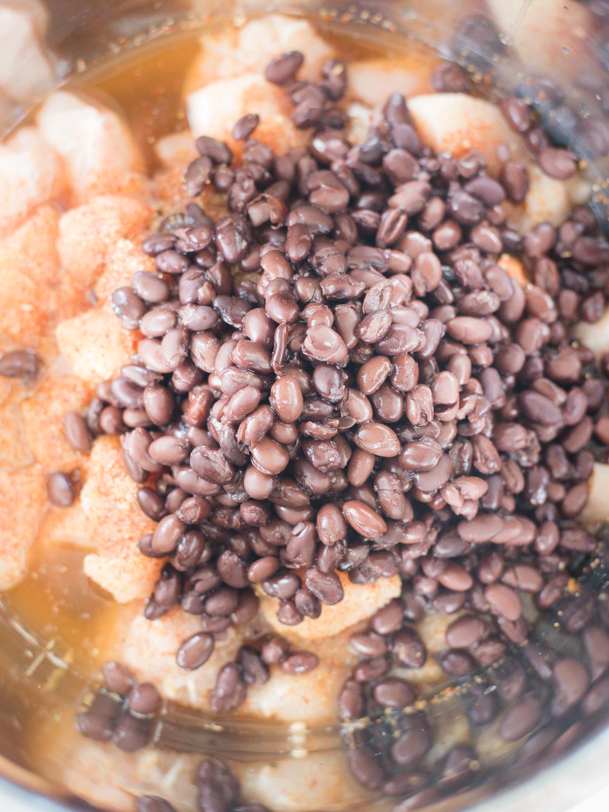 ingredients in instant pot insert with beans