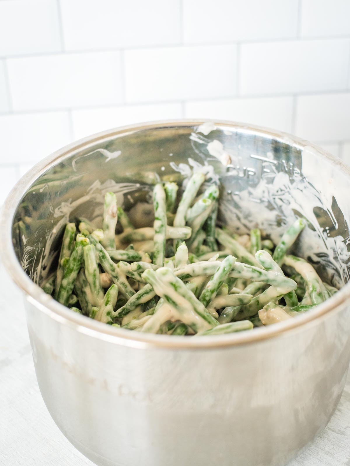 green bean casserole ingredients mixed together in instant pot sleeve