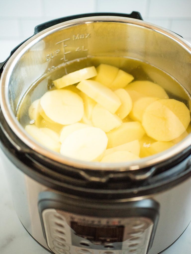 sliced potatoes in water inside instant pot