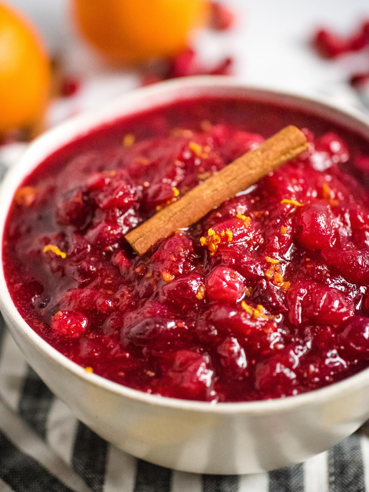 bowl full of cranberry sauce topped with a cinnamon stick