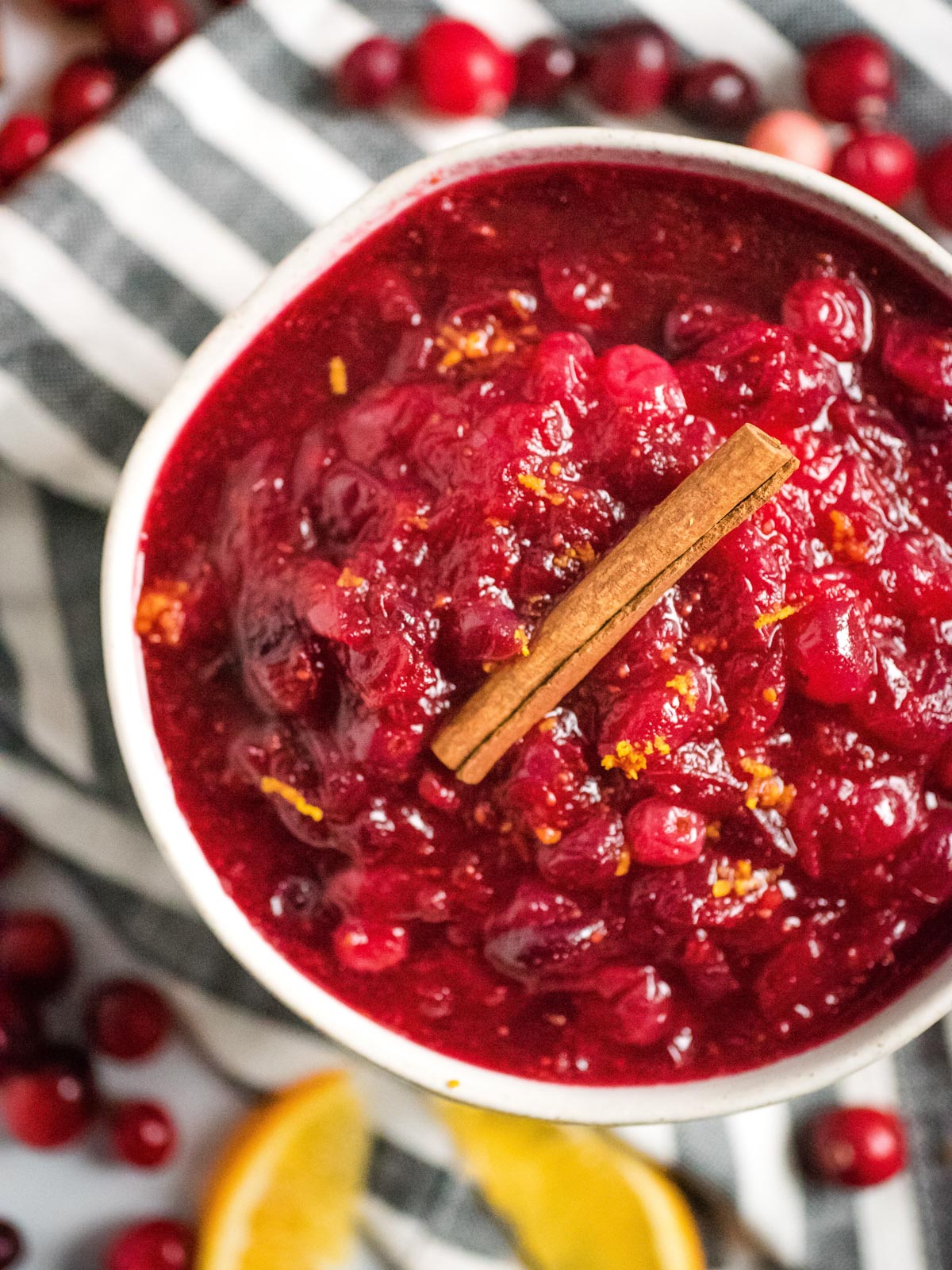 bowl full of instant pot cranberry sauce topped with a cinnamon stick