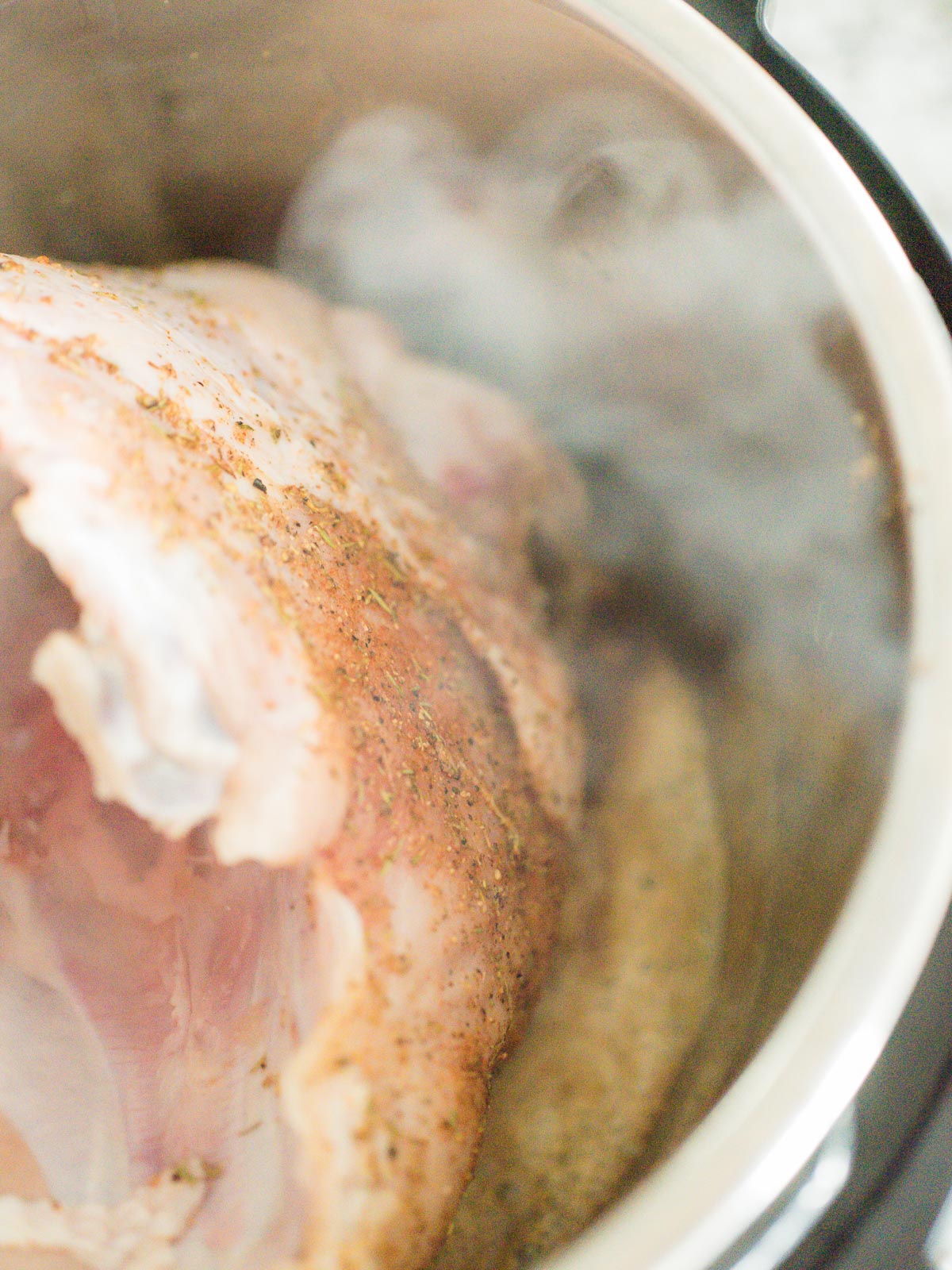 raw turkey breast with seasoning searing in instant pot