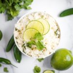 jalapeno lime rice topped with limes and cilantro
