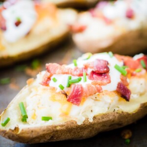 loaded twice baked potatoes on a baking sheet