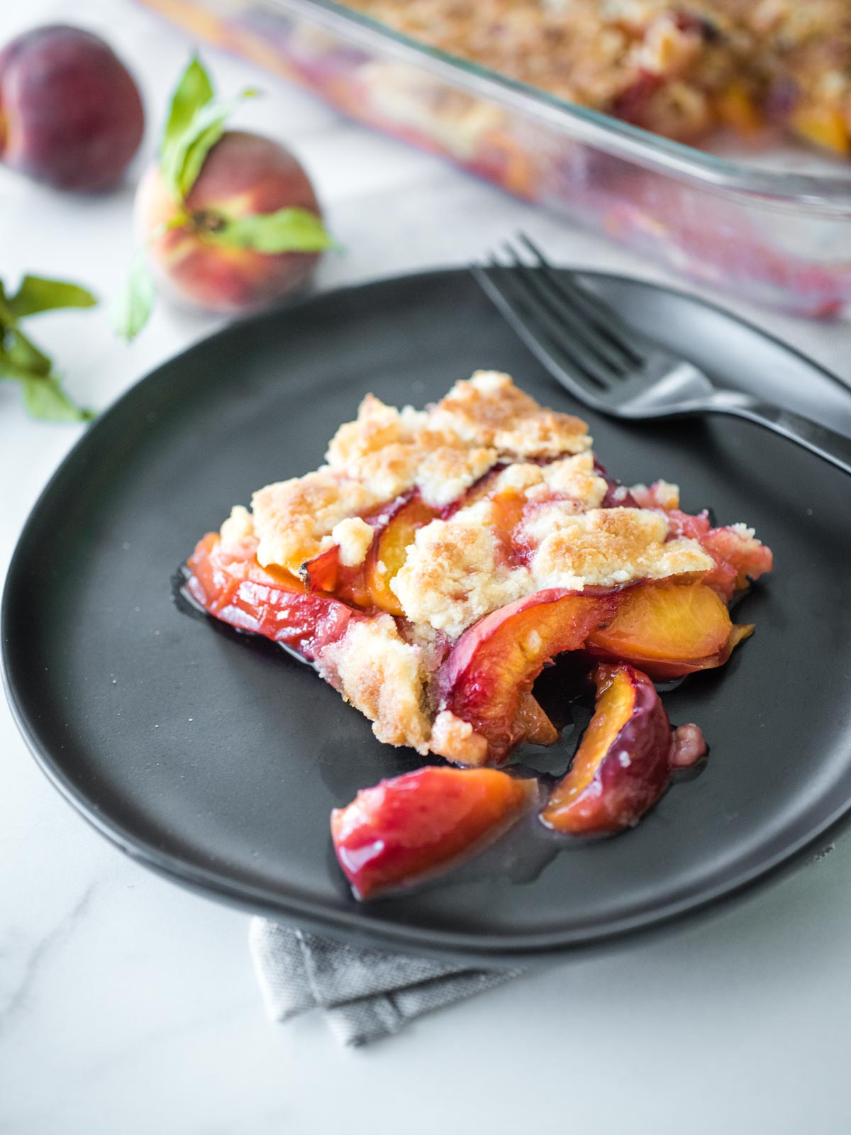 peach cobbler on a black plate