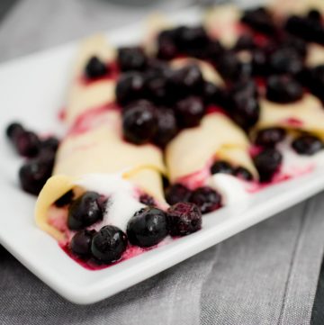 traditional crepes filled with blueberries and whipped cream