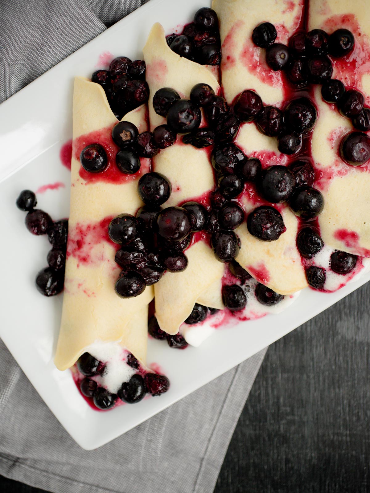 crepes filled with blueberries and whipped cream