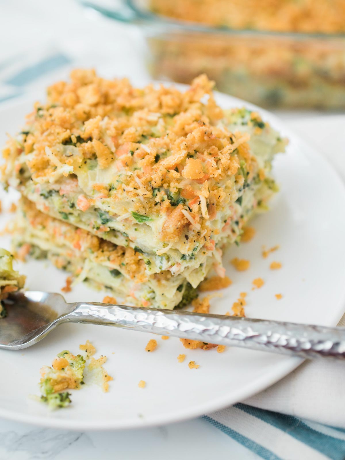 A serving of vegetable lasagna with a fork