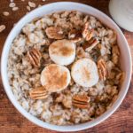 banana bread oatmeal topped with cinnamon pecans and banana