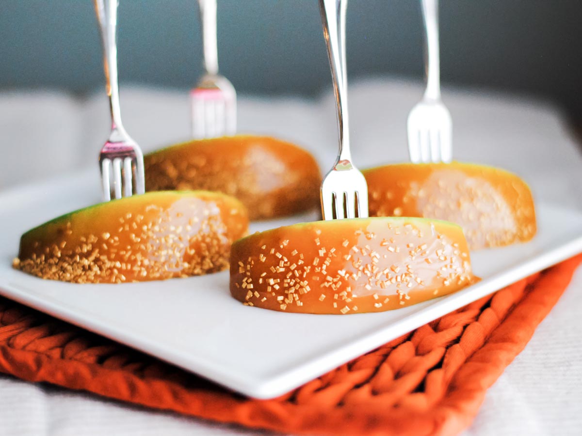 caramel apple bites on a plate with an appetizer fork