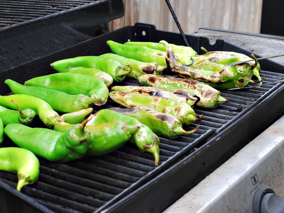 green chiles roasting on a grill