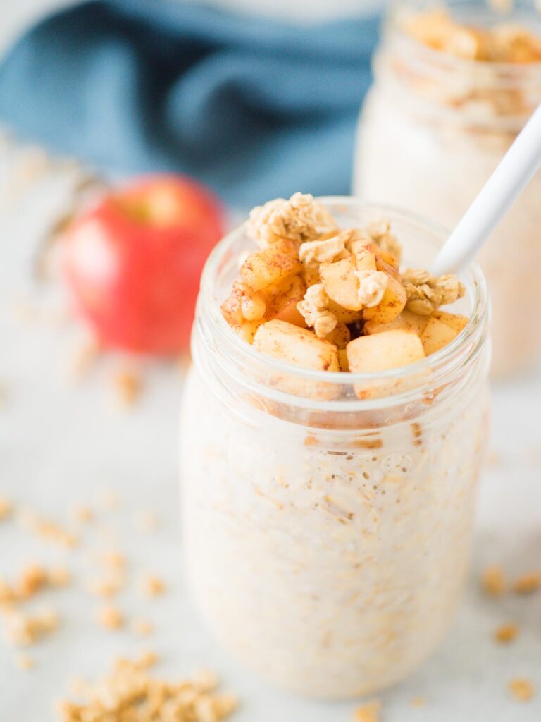 apple pie overnight oats in a jar with a spoon