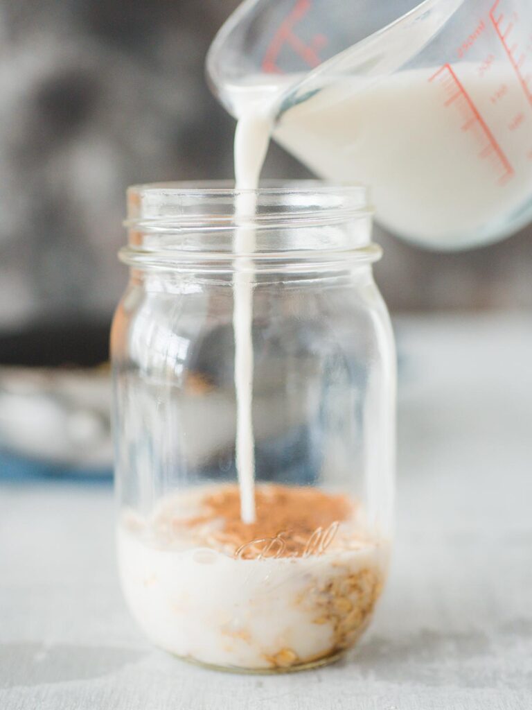 almond milk being poured into jar