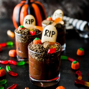 halloween dirt cups surrounded by toppings