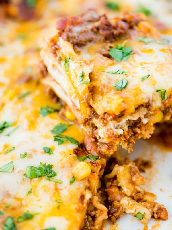 tex mex lasagna being scooped from casserole dish
