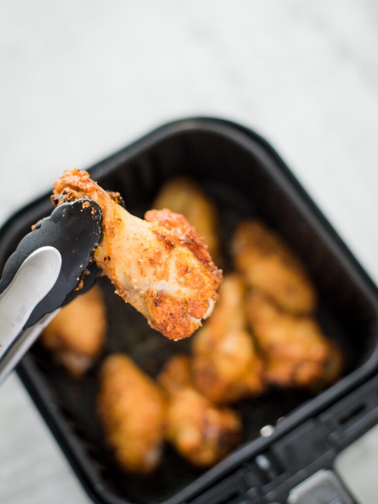 turning chicken wings over in the air fryer basket
