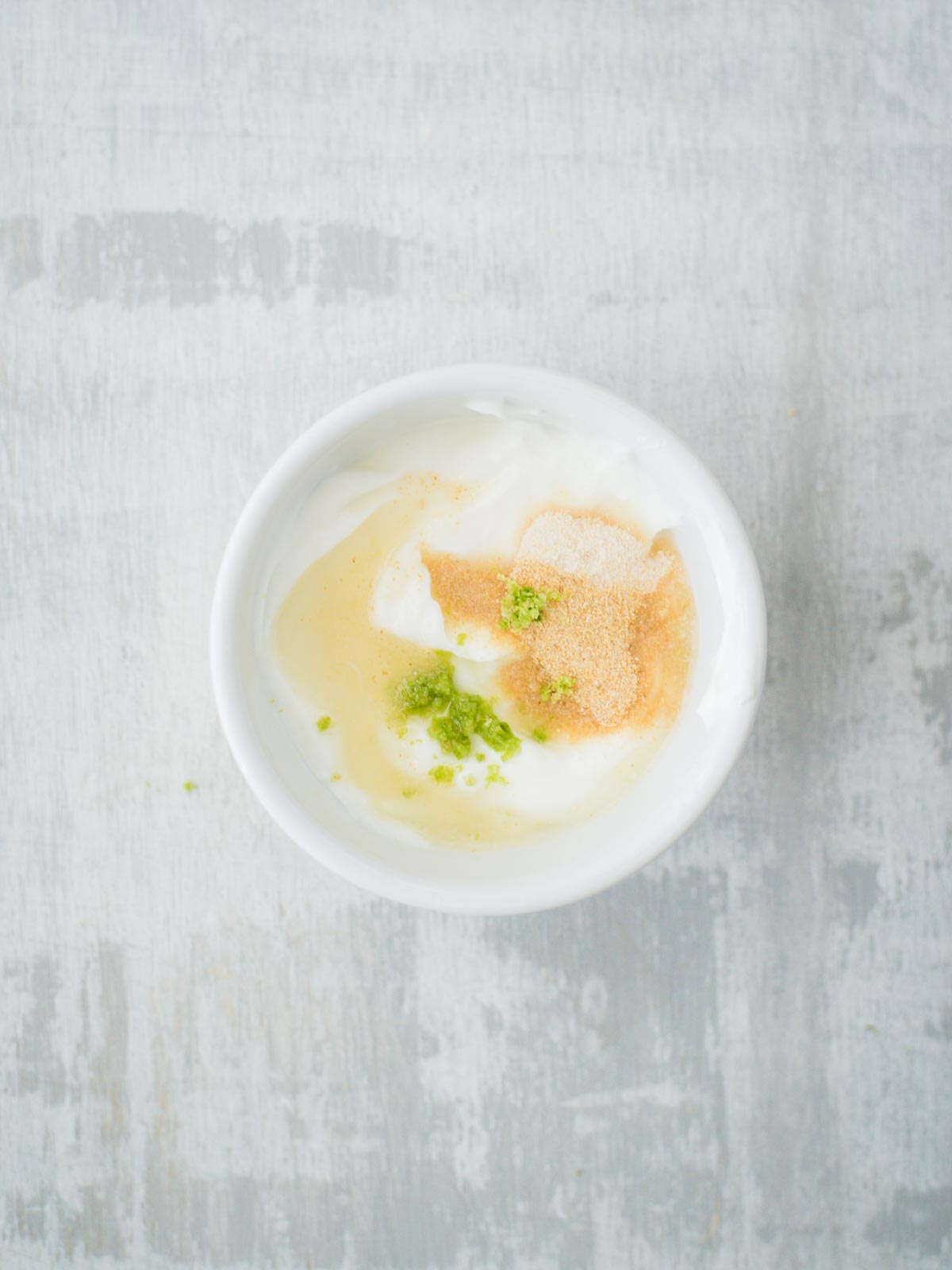 creamy lime sauce ingredients in bowl with lime juice