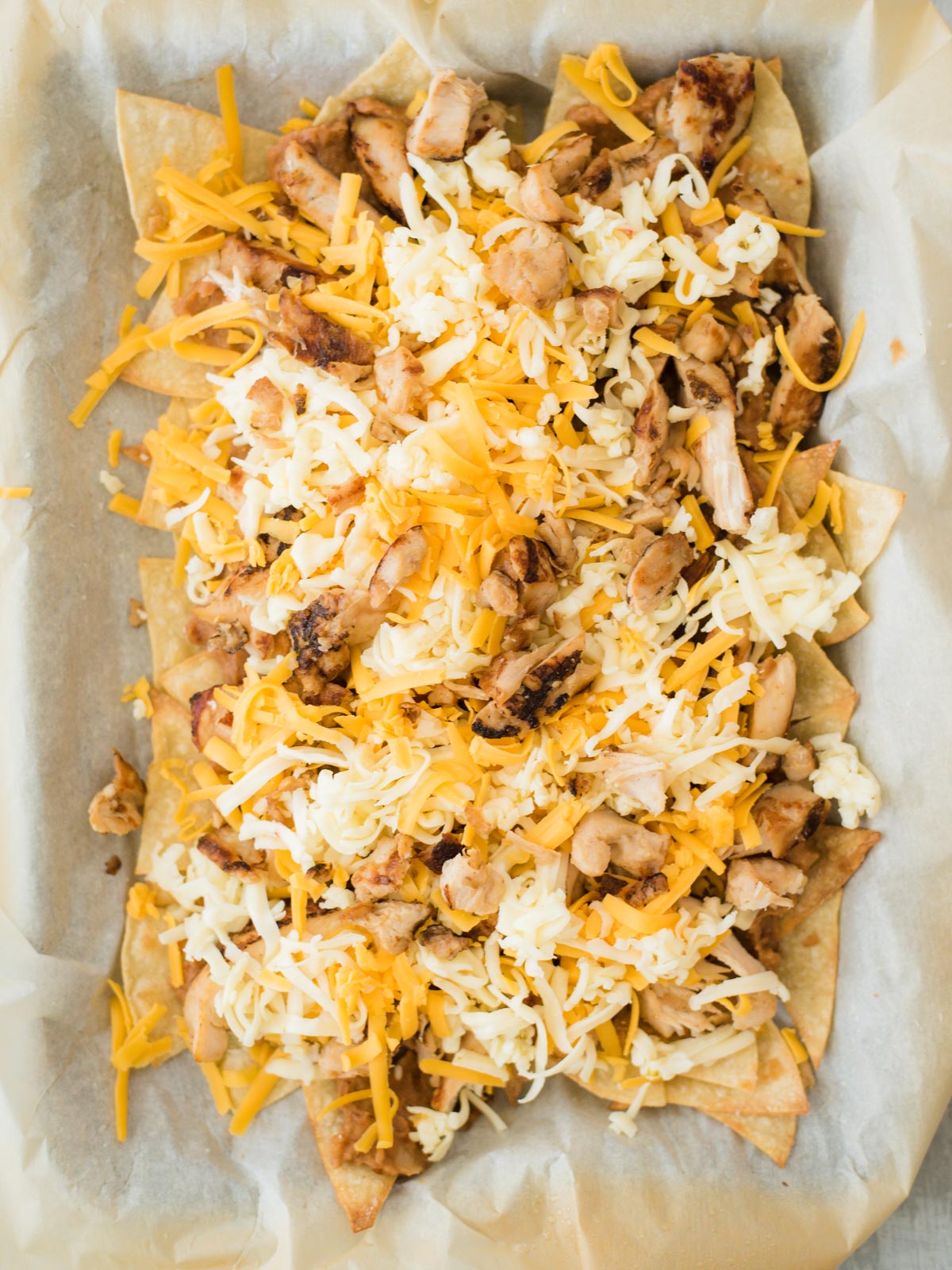 chips chicken beans and cheese layered before melted