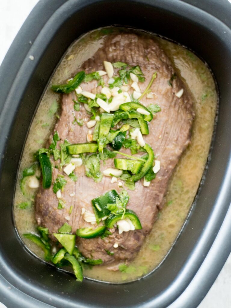 cooked flank steak in slow cooker