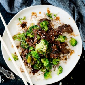 Chinese beef and broccoli served over rice topped with sesame seeds