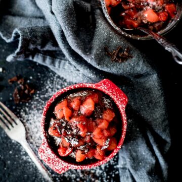Chocolate Mug Cake with Sweet Strawberry Topping and powdered sugar