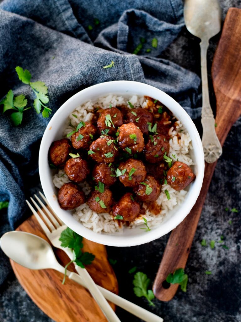 crockpot sweet and spicy meatballs topped with parsley
